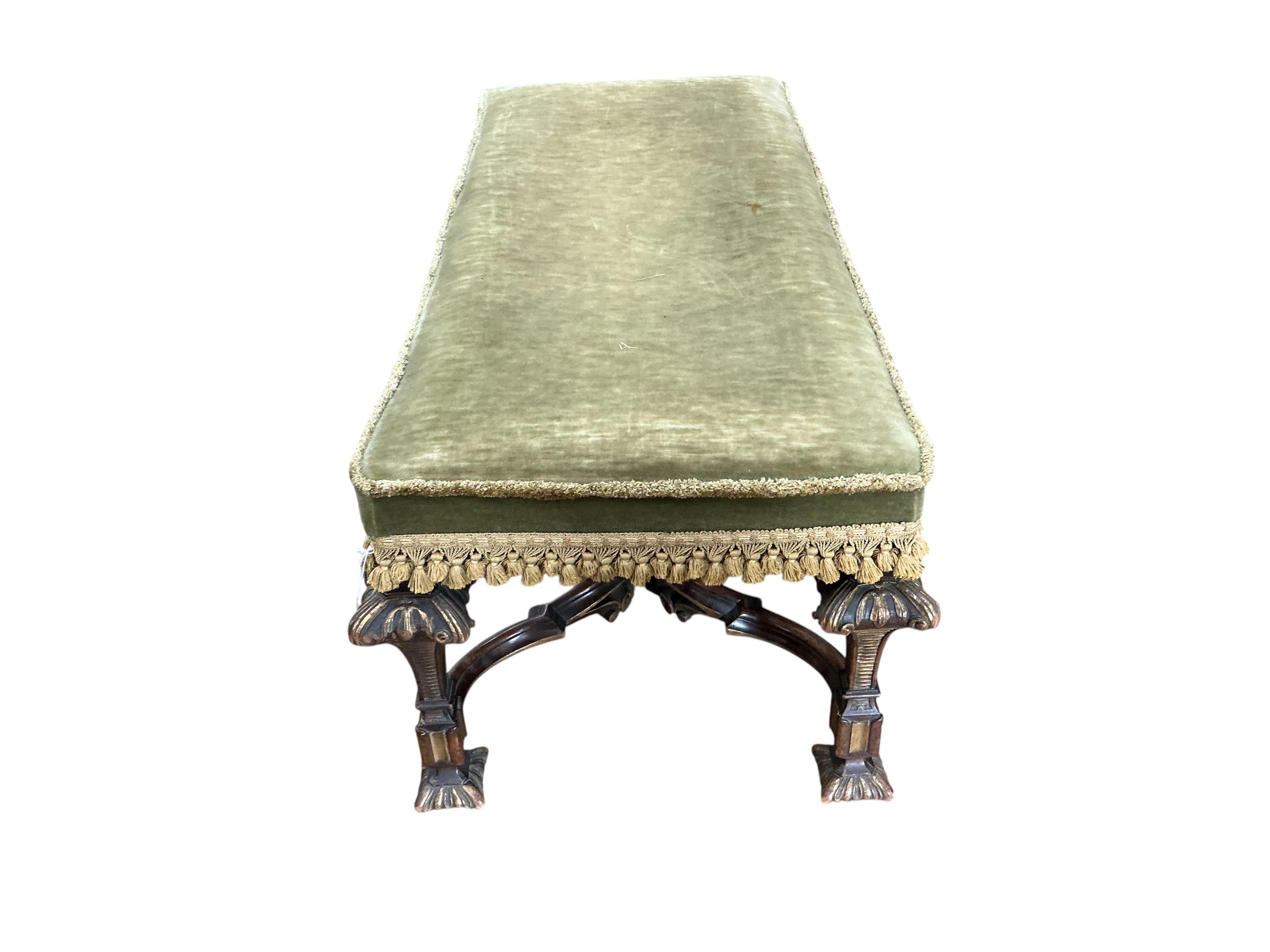 An 18th century style upholstered parcel gilt walnut stool, width 110cm, depth 48cm, height 44cm